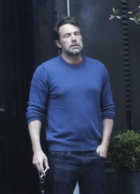 another picture of Ben Affleck, only this time he's leaning back against the corner of a building, cigarette hanging loosely from a hand at his side. his eyes are closed and he has a look of exhaustion on his face